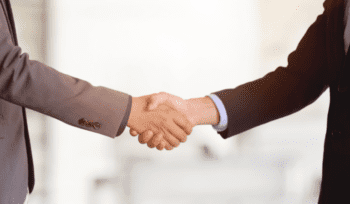 Financial Planner Shaking Hands With Business Owner
