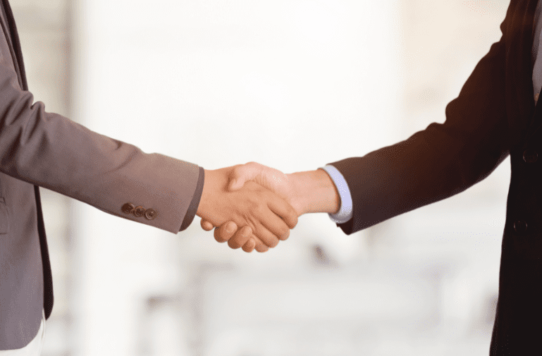 Financial Planner Shaking Hands With Business Owner